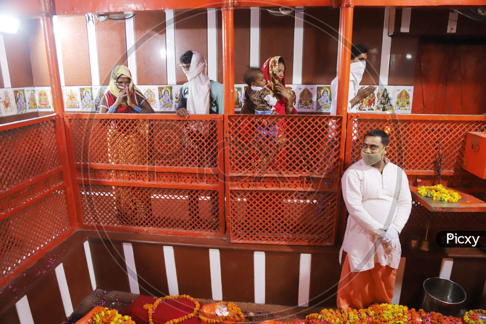 Hindu Devotees Offer Prayers After Reopening of a Temple , In Prayagraj, June 8, 2020.