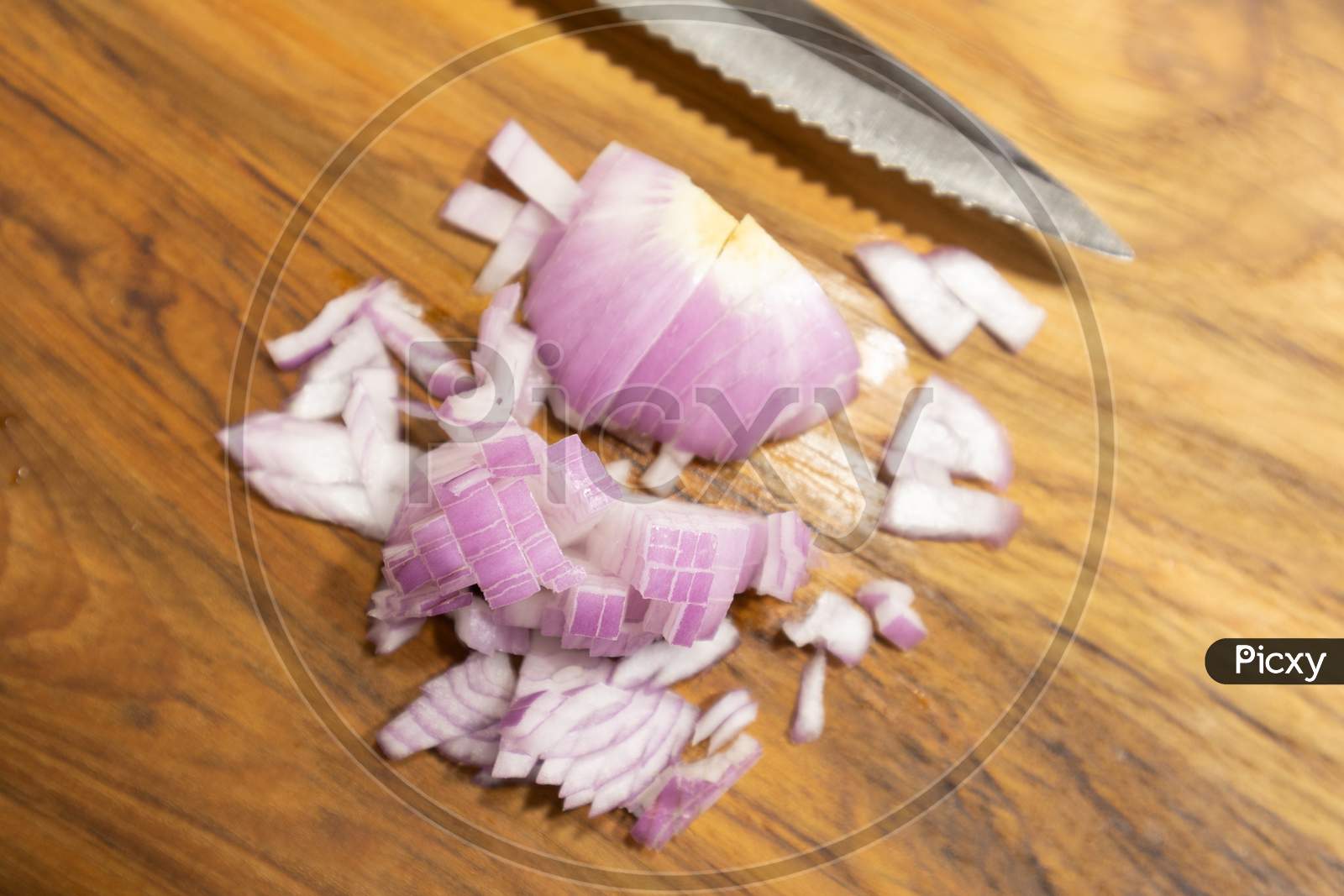 Close Up Chopped Red Onion On The Kitchen Cutting Board With Knife.