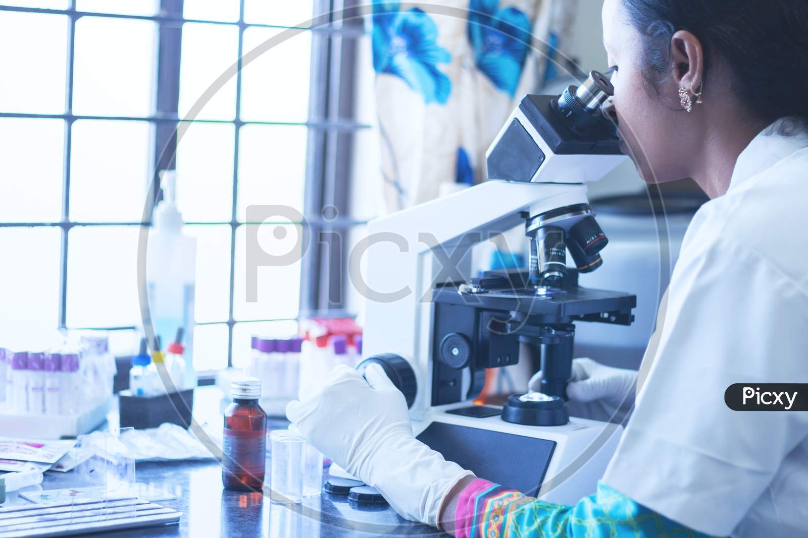 Pharma Student Using Microscope In A Laboratory