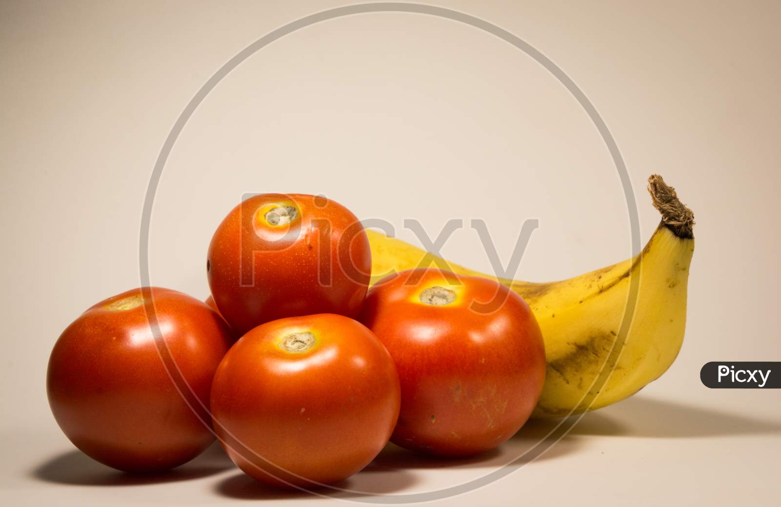 Tomatoes and Banana Isolated On A White Background.