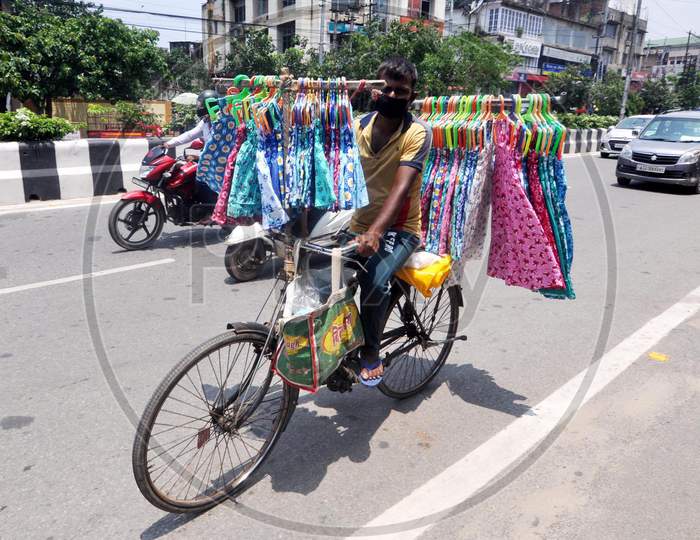 A Man Carries Clothes On His Bicycle For Sale During The Fifth Phase Of Covid-19 Nationwide Lockdown In Guwahati On June 8,2020.