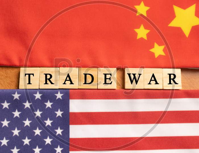 China-Us Trade War Concept - Flag Of China And The United States With Wooden Block Lettes