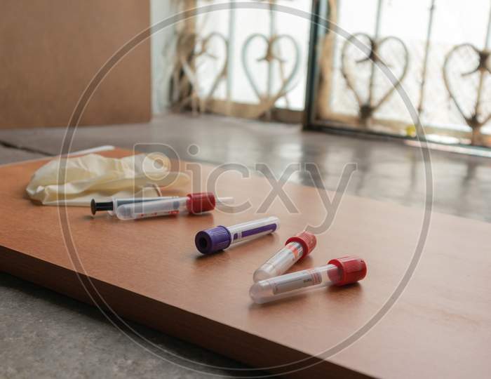 Plain Clot Bloot Activators And Syringe'S On Wooden Textured Table In Laboratory