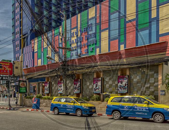 Pattaya,Thailand - October 21,2019;Second Road Two Taxis Were Standing In Front Of The Colorful Sabaai Massage,Which Is Spezialized In Adult Entertainment.