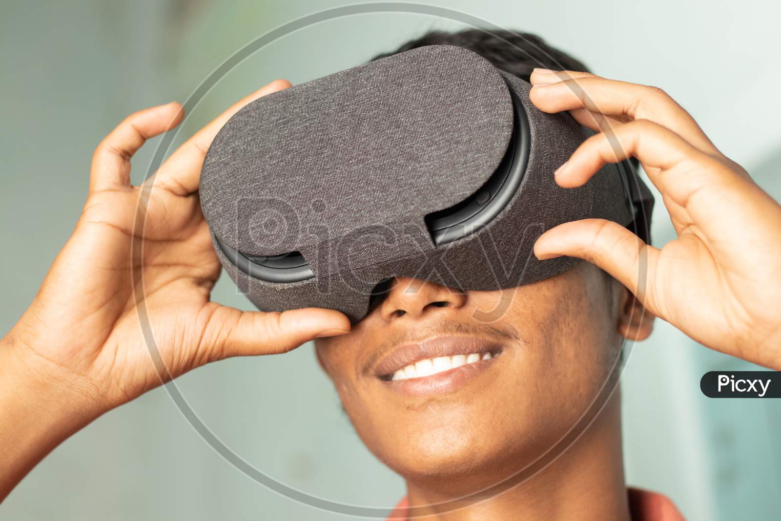 Closeup Of A Young Man Experiencing Virtual Reality Through A Vr Headset.