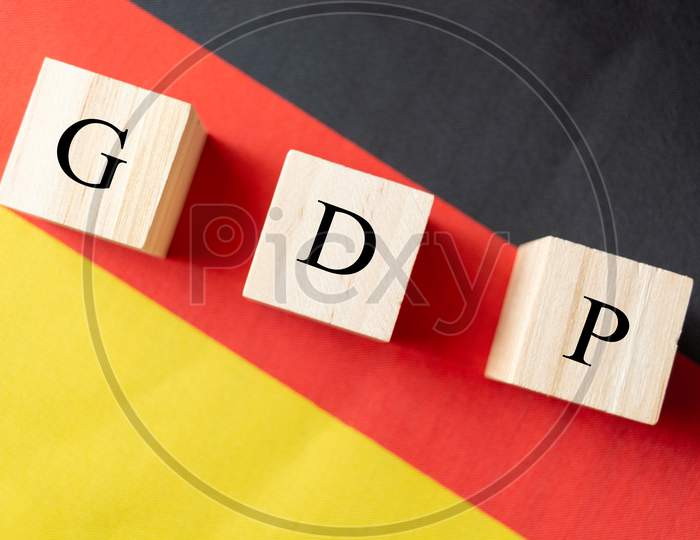 Concept Of Gross Domestic Product Or Gdp Of Germany, Gdp In Wooden Block Letter On German Flag.