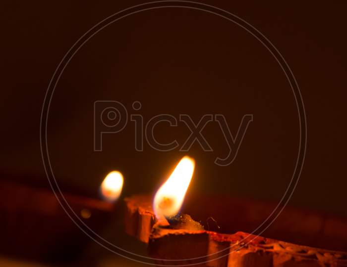 Closeup Of Diwali Terracotta Diyas On Dark Background Which Are Used Lighting Up The House During Diwali Times.