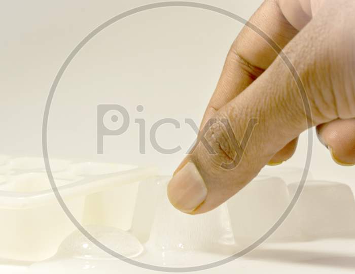 A Person removing Ice Cubes from the Ice tray