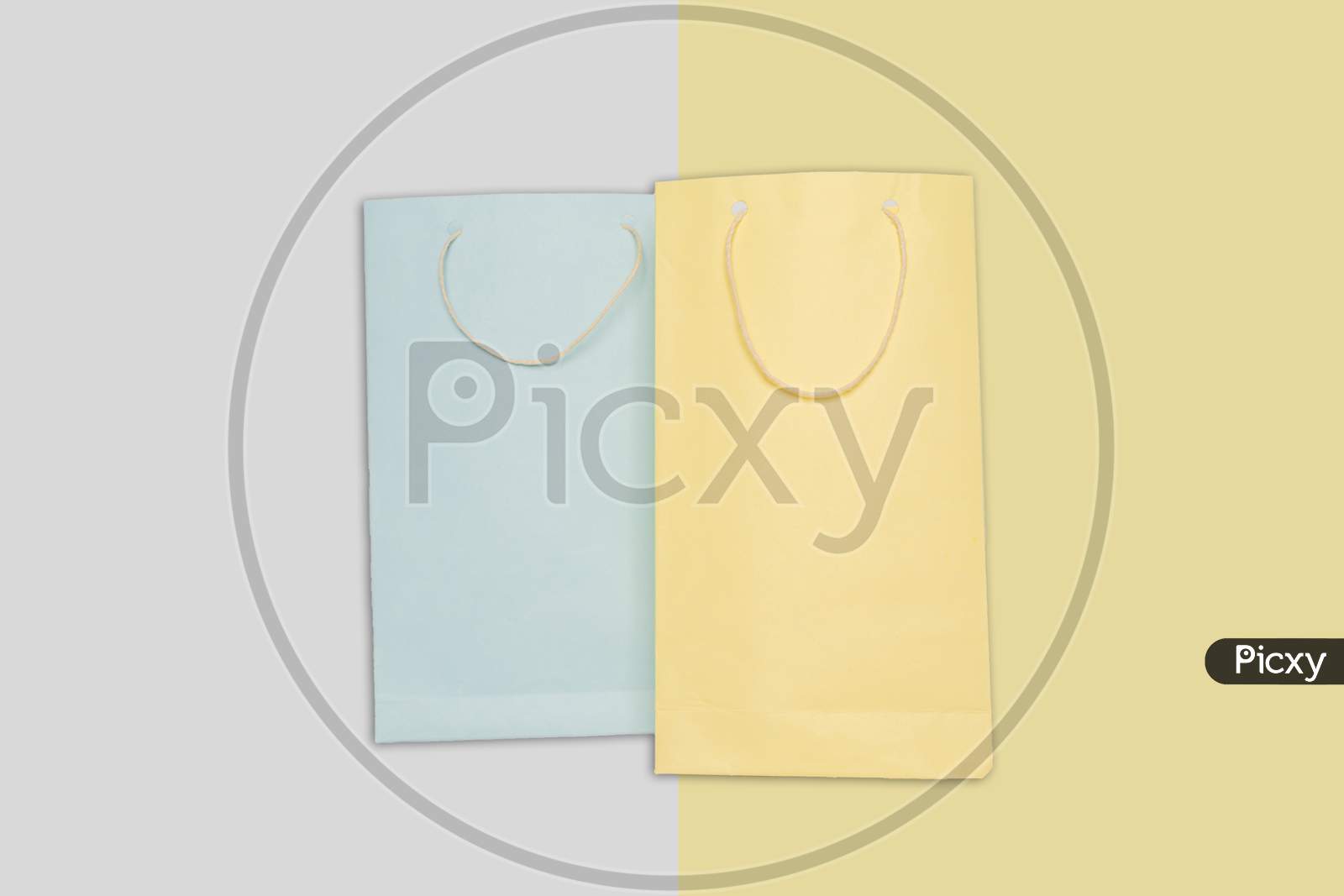 Light Blue And Yellow Color Shopping Paper Bag On Colorfull Background.