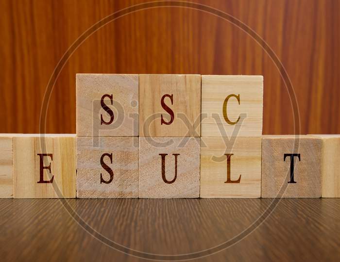 Concept Of Ssc Exam Results Conducted In India, In Wooden Block Letters On Table