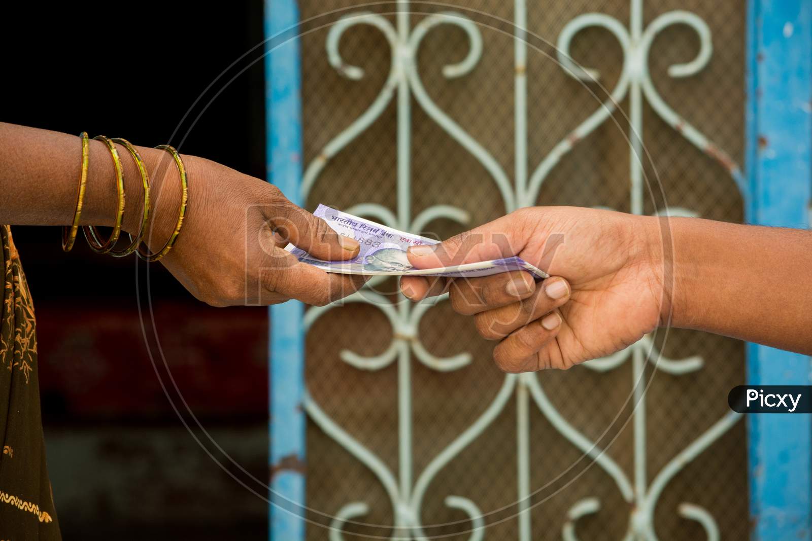Close Up Of Hands Indian Women Taking Money In Front Of The House.