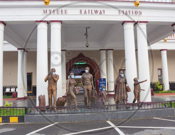 Mask wearing bronze sculptures at Mysore Railway Station