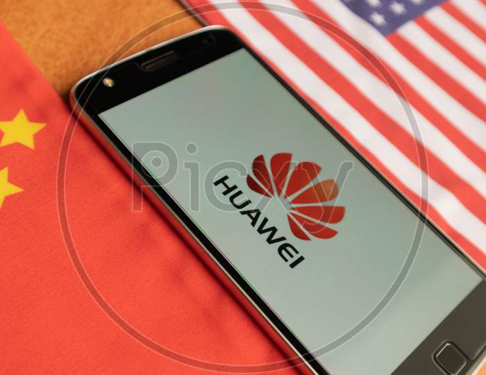 Bangalore, India, June 4, 2019 : Huawei Logo In Mobile, Kept In Between The Us And China Flag.