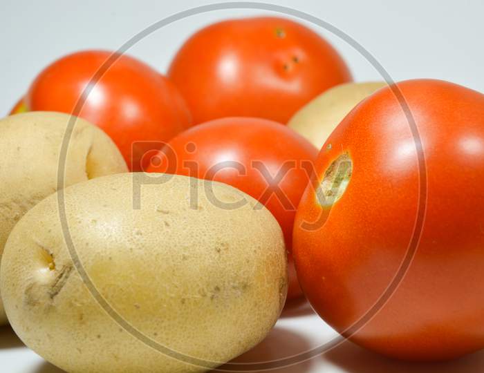 Tomatoes and Potato vegetables isolated with white background