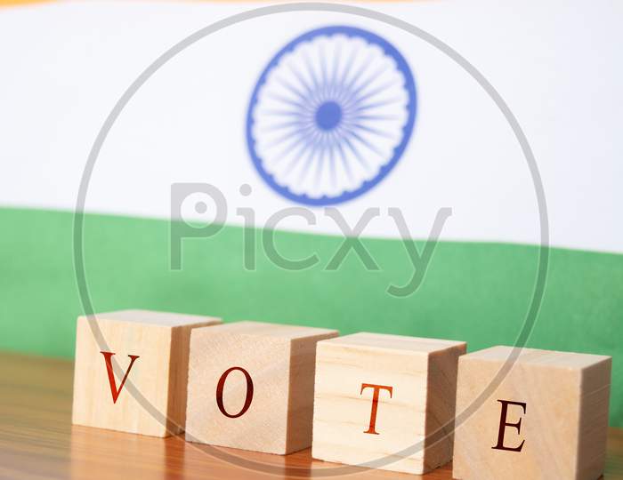 Concept Of Indian Election, Vote In Wooden Letters On Table, Indian Flalg As A Background.