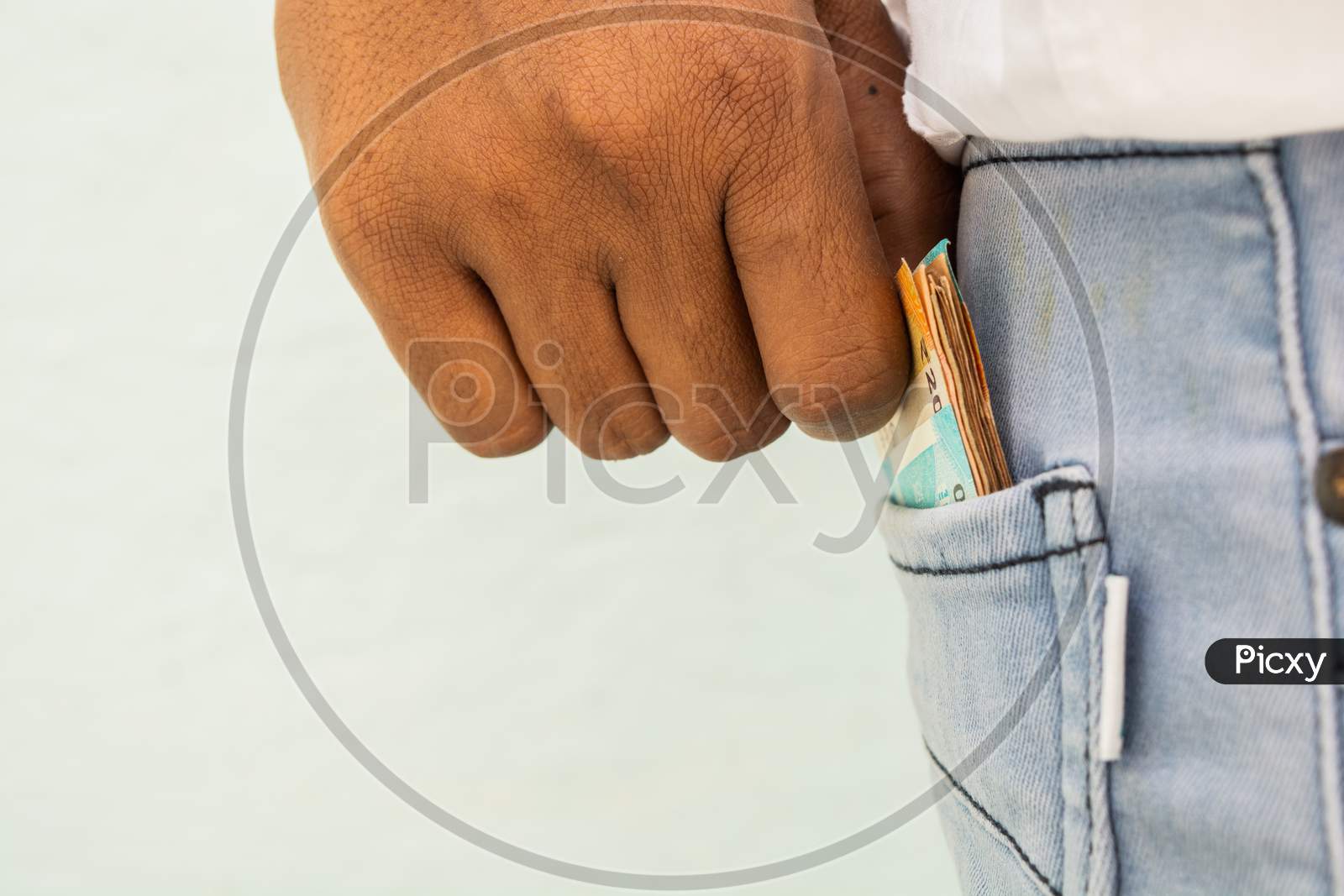 Closeup Of Man Hands Taking Currency Notes Form His Pocket.