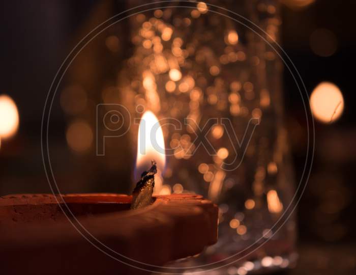 Close up shot of a Lighted Diya with Bokeh Background