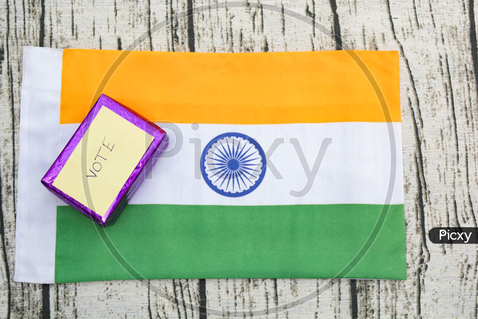 Concept Of Showing A Gift For Vote,Gift Box With Vote Sticker On Indian Flag.