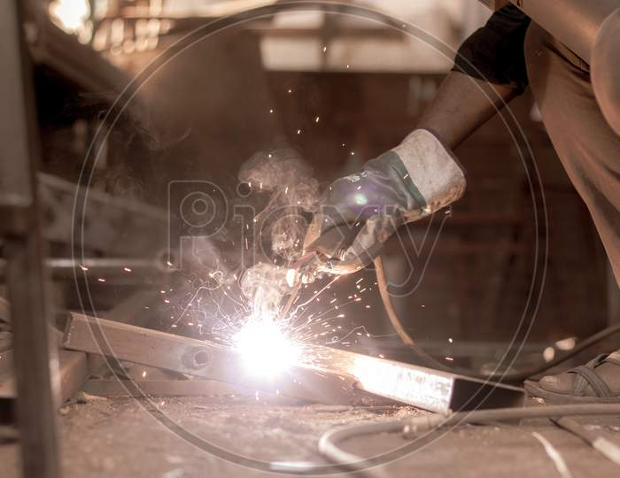 Close up shot of A Young Welder doing welding