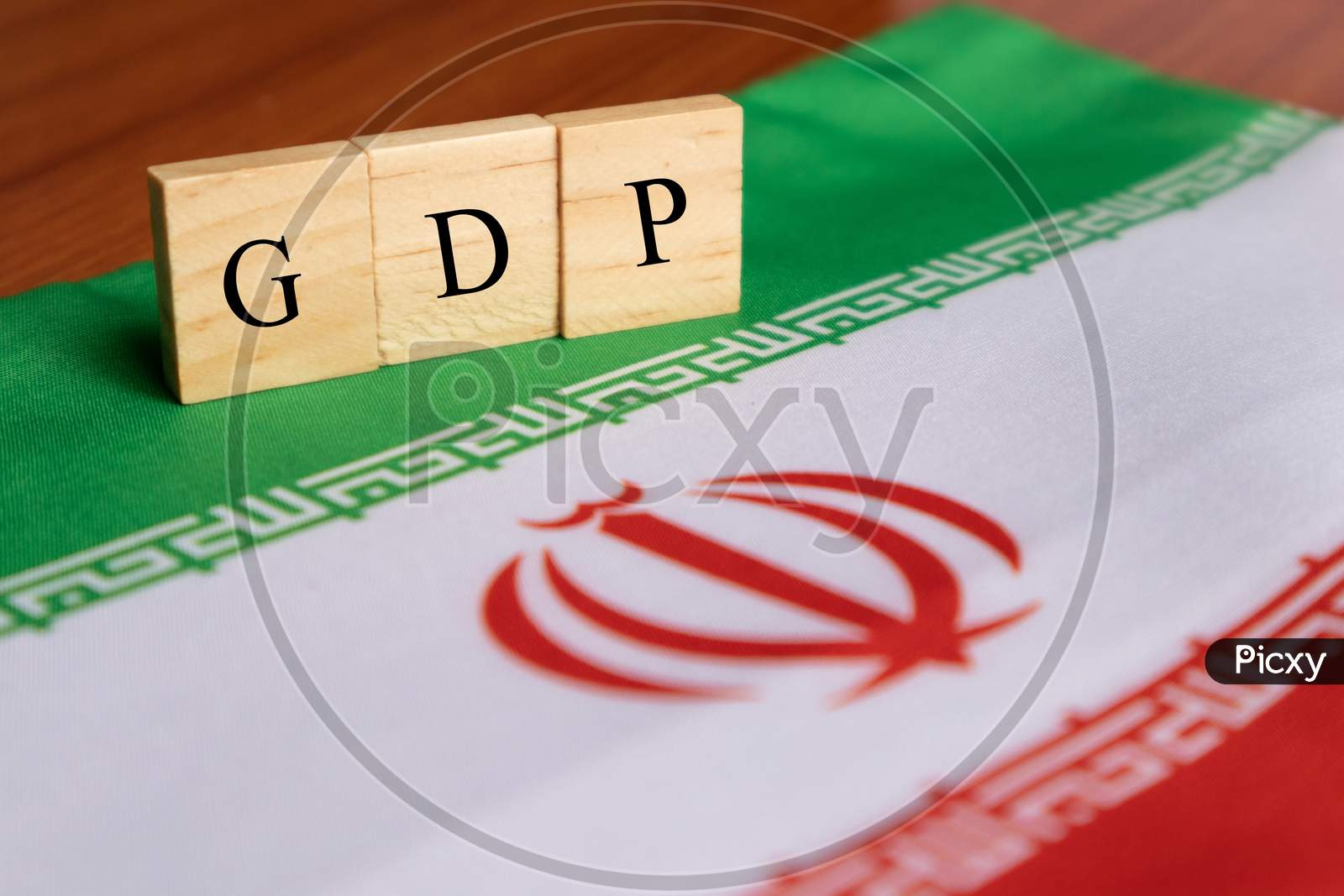 Gross Domestic Product Or Gdp Of Iran In Wooden Block Letters On Iran Flag.