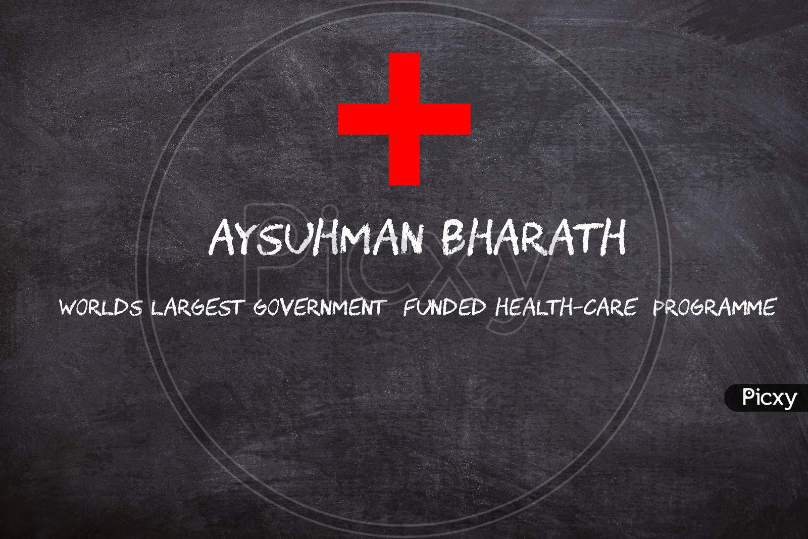 Ayushman Bharath written on a Black Chalk piece board