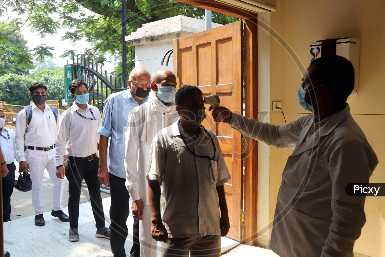 A Paramedic Conducts Thermal Scanning for Allahabad High Court Advocates And Employees after its Reopening, In Prayagraj, June 8, 2020.