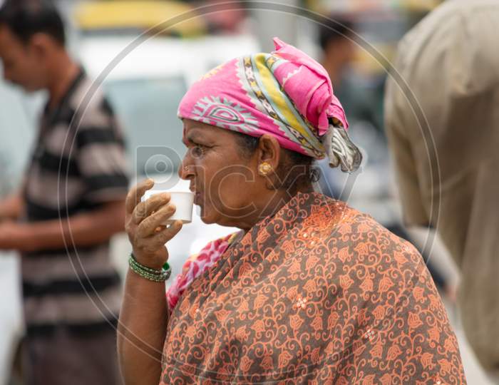 Bangalore, Karnataka India-June 04 2019 : Indian Woman Drinking Tea On Street After Completing The Work.