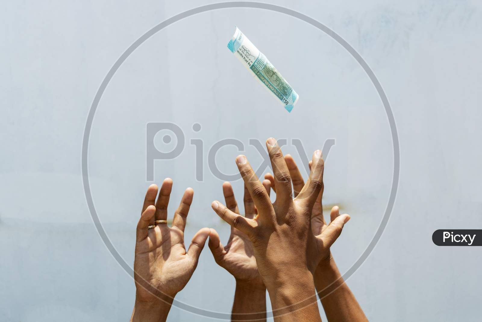 Hands Trying To Get Or Catch The Flying Money On Isolated Background.