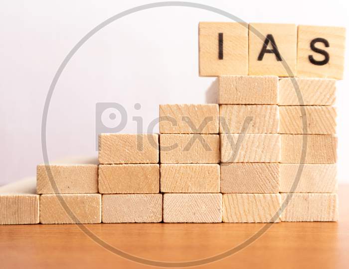 On Wooden Toy Steps Ias Or Indian Administration Service In Wooden Block Letters.