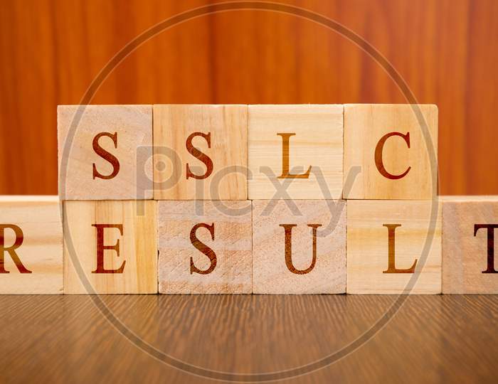 Concept Of Sslc Exam Results Conducted In India, In Wooden Block Letters On Table
