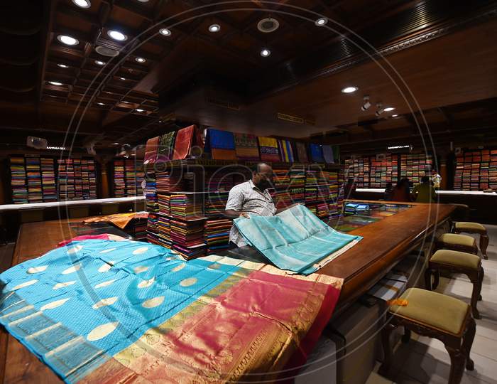 A Salesman Arranges Sarees At A Showroom After Reopening of shops post the lockdown, in Chennai, Tamil Nadu