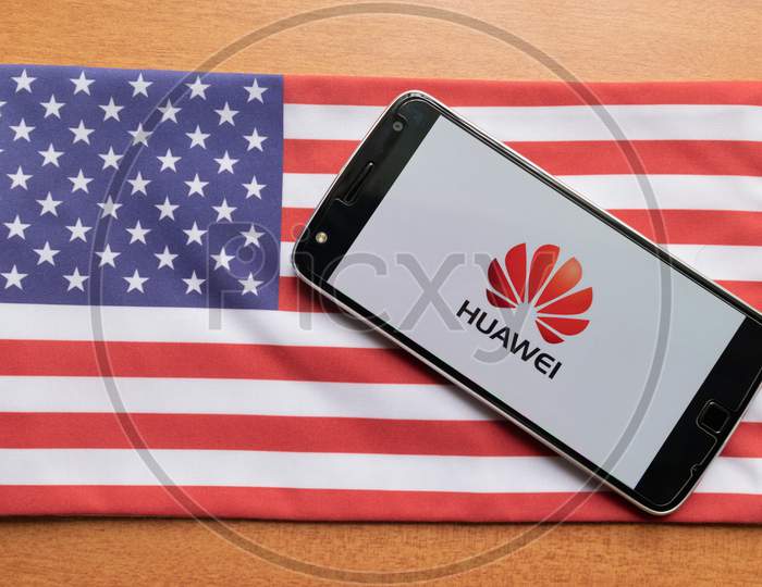 Huawei Logo On Screen Of Mobile On Us Flag