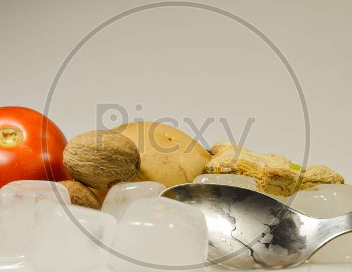 Tomato, Potato, Ginger and Chillies with the ice cubes isolated with white background