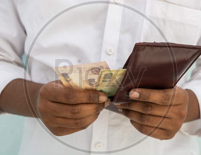 Closeup Of Man Hands Taking Indian Currency Out Of His Wallet