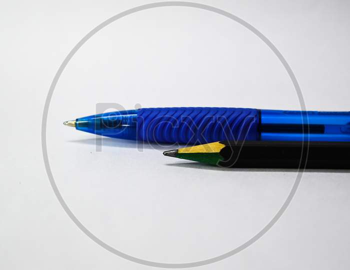 Black Pencil And Blue Pen Isolated On White Background. Selective Focus Applied.