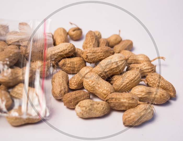 Groundnuts Or Peanuts Coming Out Of The Plastic Bag On Isolated Background