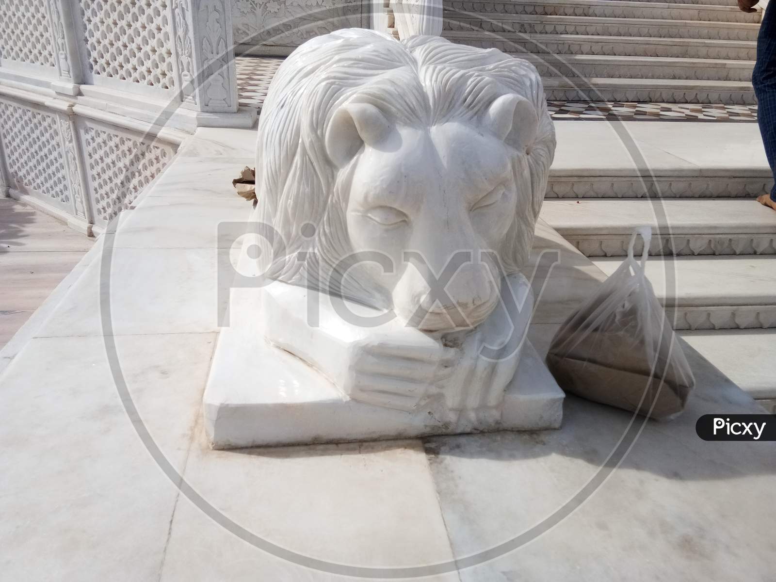 A statue of a sleeping lion on the main door of Karni Mata temple in Rajasthan
