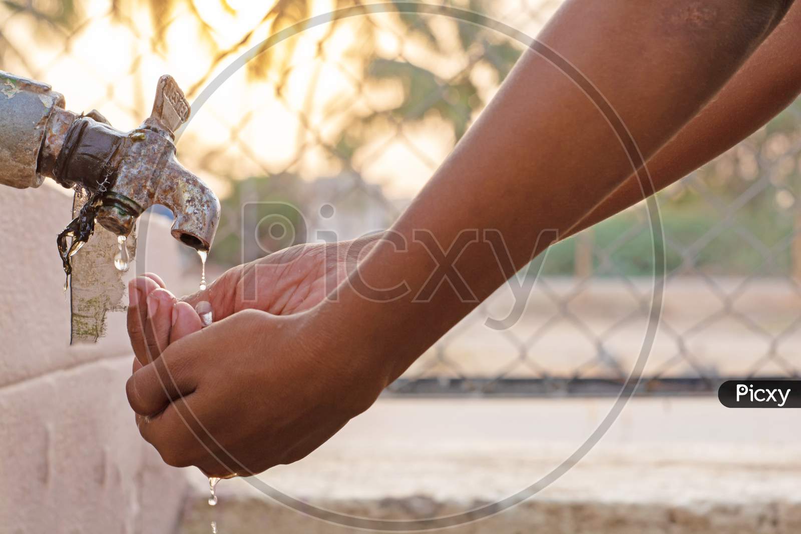 Closeup Of Hands, Child Drinking Water Directly From Corporation Tap Water In India