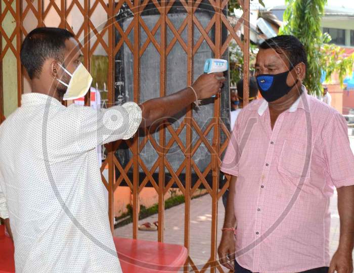 Thermal Screening Being Conducted Outside Sukerswar Temple After The Authorities Permitted Opening Of All Religious Places With Certain Restrictions, During The Fifth Phase Of Ongoing Covid-19 Lockdown, In Guwahati, Monday, June 8, 2020.