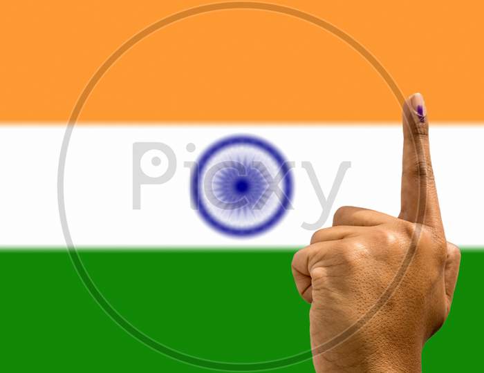 A Person showing Voted Finger with Indian Flag in the Background