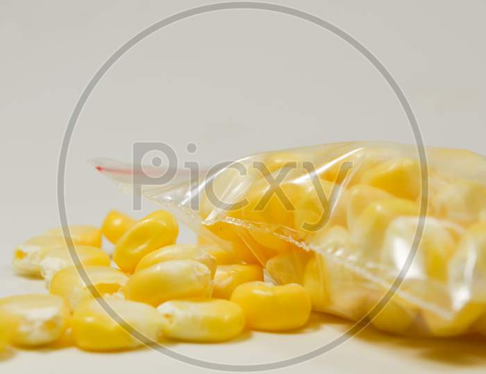Close up shot of Peeled corn in a packet isolated with the White Background