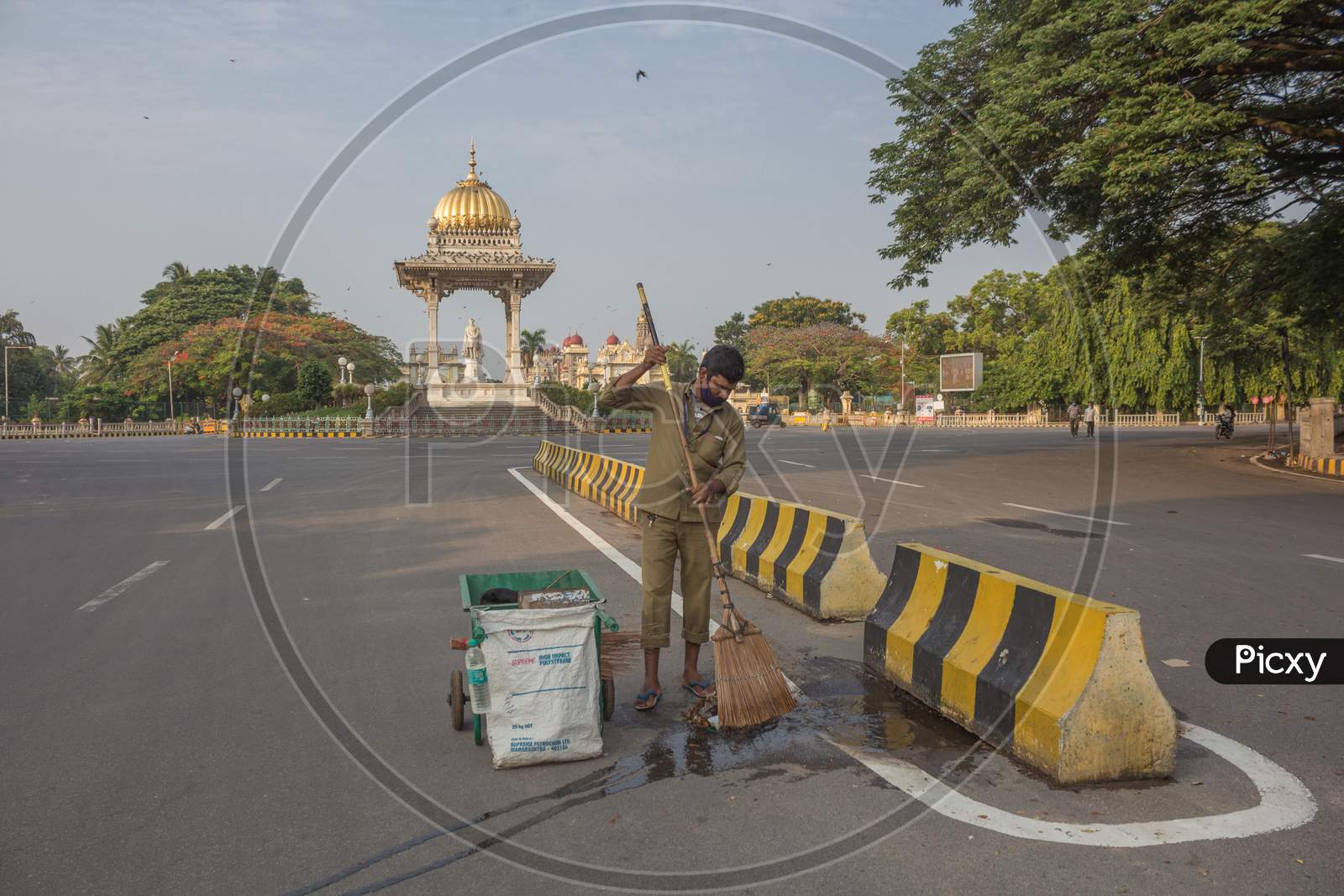 An Health worker cleaning the road near Mysore Palace