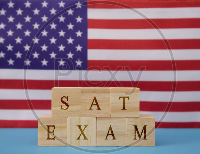 Sat Exam In Wooden Block Letters On Us Flag.