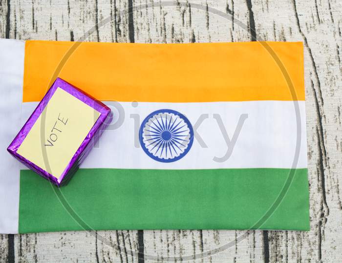 Concept Of Showing A Gift For Vote,Gift Box With Vote Sticker On Indian Flag.