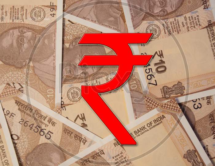 Scattered Indian 10 Rupee Currency Notes With Rupee Symbol.