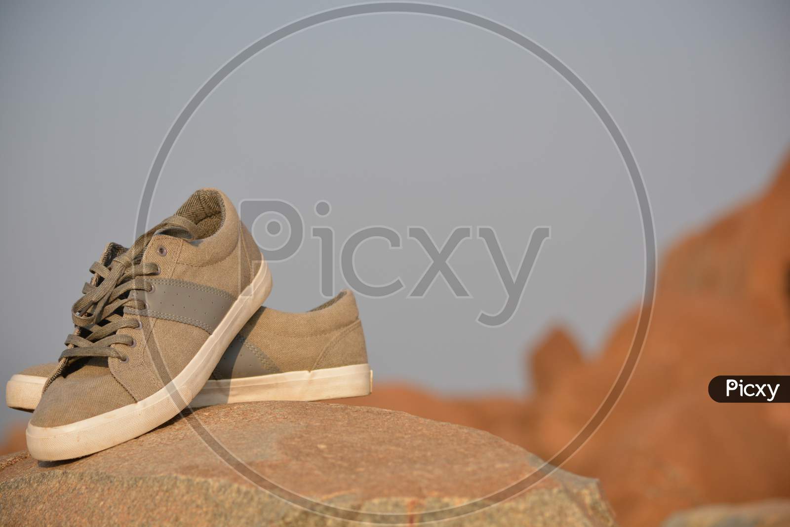 Stylish Men Olive Green Sneakers Or Regular Shoes On Top Of The Mountain.