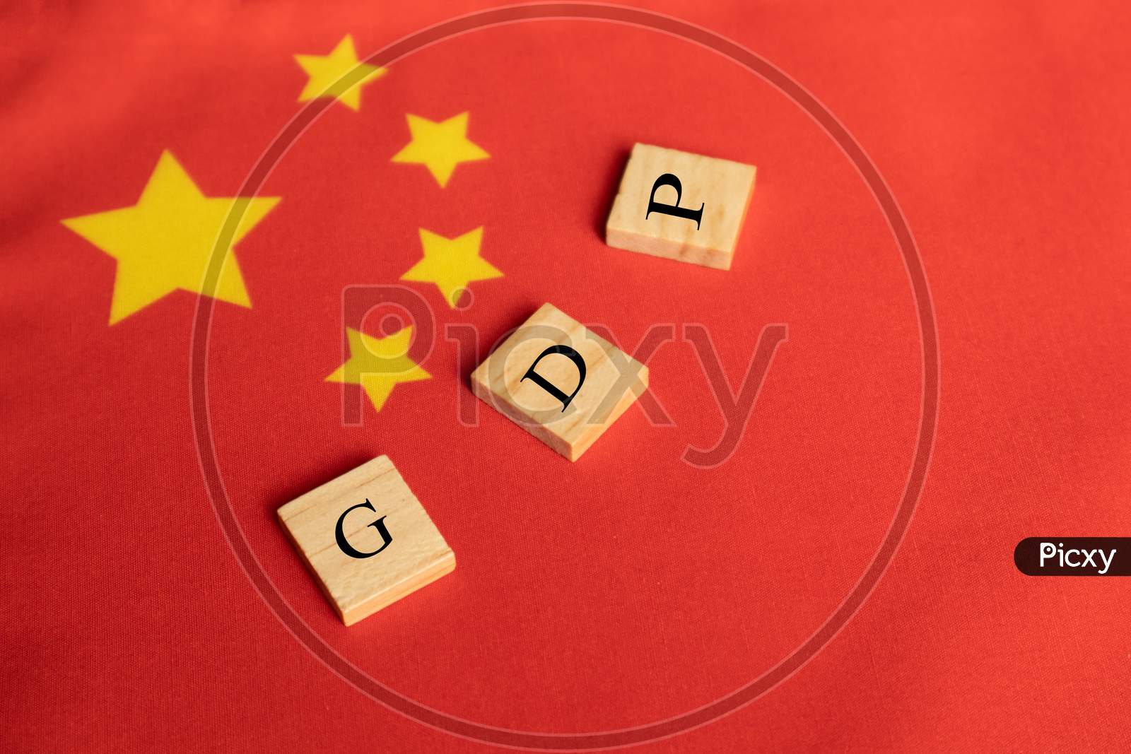Gross Domestic Product Or Gdp Of China On Wooden Block Letters On Chinese Flag.