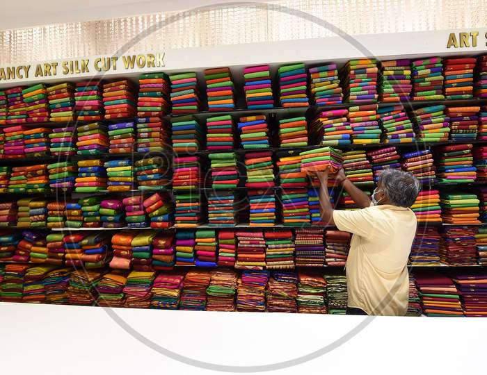 A Salesman Arranges Sarees At A Showroom After Reopening of shops post the lockdown, in Chennai, Tamil Nadu