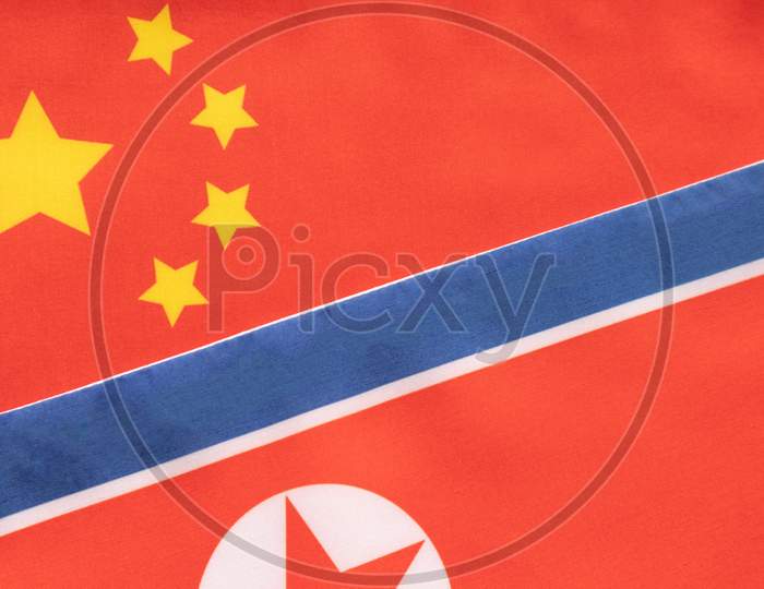 Concept Of Bilateral Relationship Between Two Countries Showing With Two Flags: China And North Korea