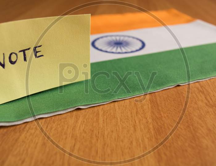 Voting Concept - Hand Written Voting Sticker On Indian Flag